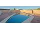Backyard swimming pool bordered with a light colored concrete edge at 4132 E Sweetwater Ave, Phoenix, AZ 85032