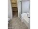 Bathroom with tiled floors, glass shower enclosure and view to closet at 4613 W Fawn Dr, Laveen, AZ 85339