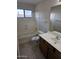 Standard bathroom with white tile tub, toilet, and sink at 4613 W Fawn Dr, Laveen, AZ 85339