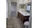 Bathroom featuring a double sink vanity, tiled floors, and neutral paint at 4613 W Fawn Dr, Laveen, AZ 85339