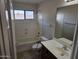 Standard bathroom with white tile tub, toilet, and sink at 4613 W Fawn Dr, Laveen, AZ 85339