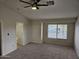 Bedroom features a ceiling fan, plush carpeting, and view to an ensuite bathroom at 4613 W Fawn Dr, Laveen, AZ 85339