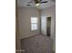 Neutral carpeted bedroom with ceiling fan, window, and closet at 4613 W Fawn Dr, Laveen, AZ 85339