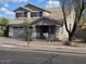 Two-story home featuring a neutral color scheme, desert landscaping, and attached two car garage at 4613 W Fawn Dr, Laveen, AZ 85339
