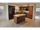 Spacious kitchen with tile floors, center island, stainless steel appliances, and wood cabinets at 4613 W Fawn Dr, Laveen, AZ 85339