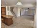 Open concept kitchen with tile floors, center island, wood cabinets, stainless steel appliances, and adjacent staircase at 4613 W Fawn Dr, Laveen, AZ 85339