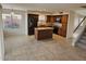 Open kitchen featuring tile floors, a center island, stainless steel appliances, and wood cabinets at 4613 W Fawn Dr, Laveen, AZ 85339