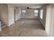 Neutral living room featuring tile entry, plush carpet, and abundant natural light from multiple windows at 4613 W Fawn Dr, Laveen, AZ 85339