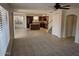 Open concept living room featuring plush carpet, neutral paint, staircase, and open access to the kitchen at 4613 W Fawn Dr, Laveen, AZ 85339