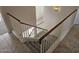 Carpeted staircase with white banisters leading upstairs from tiled landing at 4613 W Fawn Dr, Laveen, AZ 85339
