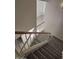 Carpeted staircase with white railing leading upstairs and a tiled landing at 4613 W Fawn Dr, Laveen, AZ 85339