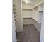 Walk-in closet featuring custom shelving and neutral colored carpeting at 4613 W Fawn Dr, Laveen, AZ 85339