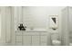 Stylish bathroom featuring white vanity, framed mirror, and neutral shower curtain at 4752 E Topaz Dr, San Tan Valley, AZ 85140