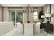 Cozy dining room with a wooden table, white chairs, chandelier, view to living room, and sliding glass door at 4752 E Topaz Dr, San Tan Valley, AZ 85140
