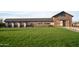 Community entrance with stone accents, lush grass, and signage for Bella Vista Farms at 4752 E Topaz Dr, San Tan Valley, AZ 85140