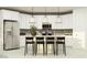 Bright modern kitchen with white cabinets, stainless appliances, kitchen island with pendant lighting and seating at 4752 E Topaz Dr, San Tan Valley, AZ 85140