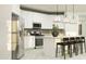 Bright modern kitchen with white cabinets, stainless appliances, kitchen island with pendant lighting and seating at 4752 E Topaz Dr, San Tan Valley, AZ 85140