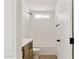 Bright bathroom with white tiled shower and wood-tone vanity cabinet at 51210 W Bluejay St, Maricopa, AZ 85139