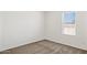 Cozy bedroom featuring neutral carpet and a window for natural light at 51210 W Bluejay St, Maricopa, AZ 85139