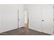 Bedroom with carpeting, doors, and a view into the bathroom at 51210 W Bluejay St, Maricopa, AZ 85139