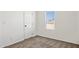 Bedroom with plush carpeting, a window with views, and a white door at 51210 W Bluejay St, Maricopa, AZ 85139