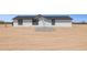 Charming single-story home with clean white siding, dark roof, and stone detail pathway in a desert landscape at 51210 W Bluejay St, Maricopa, AZ 85139