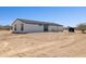 Rear exterior view highlighting the home's patio and water tank at 51210 W Bluejay St, Maricopa, AZ 85139