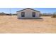 Rear exterior showcasing white siding and dark framed windows at 51210 W Bluejay St, Maricopa, AZ 85139