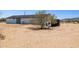 Exterior side view with tank and desert landscaping at 51210 W Bluejay St, Maricopa, AZ 85139