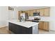 Modern kitchen with stainless steel appliances, white countertops, and stylish cabinetry in a newly built home at 51210 W Bluejay St, Maricopa, AZ 85139