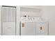Laundry area showcasing the included washer and dryer appliances at 51210 W Bluejay St, Maricopa, AZ 85139