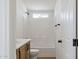 Bathroom featuring modern finishes, a tub, shower, and light wood cabinets at 51288 W Bluejay St, Maricopa, AZ 85139