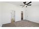 A bedroom with carpet flooring, a ceiling fan, and access to a bathroom and closet at 51288 W Bluejay St, Maricopa, AZ 85139