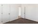 Inviting carpeted bedroom with closet and doorway provides functionality and style at 51288 W Bluejay St, Maricopa, AZ 85139