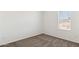 Neutral-toned bedroom with carpet and a bright window illuminating the space at 51288 W Bluejay St, Maricopa, AZ 85139