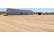 Home exterior view with a water tank and a natural desert landscape at 51288 W Bluejay St, Maricopa, AZ 85139