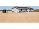 Side view of a gray house, highlighting utilities and desert landscape at 51288 W Bluejay St, Maricopa, AZ 85139