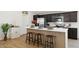 Well-lit kitchen featuring a stylish island with barstool seating and stainless appliances at 51288 W Bluejay St, Maricopa, AZ 85139