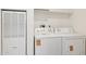Bright laundry room with functional appliances and ample storage space above at 51288 W Bluejay St, Maricopa, AZ 85139