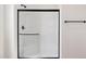 Shower showcasing a black framed glass enclosure and white tiled walls at 51288 W Bluejay St, Maricopa, AZ 85139