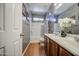 This bathroom features a shower-tub combo, and a large vanity with double sinks at 5342 W Maldonado Rd, Laveen, AZ 85339