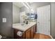 Bathroom features wood cabinets, double sinks, and a large mirror at 5342 W Maldonado Rd, Laveen, AZ 85339