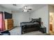 This bedroom features a ceiling fan, a large bed, and a small plant at 5342 W Maldonado Rd, Laveen, AZ 85339