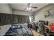This is a bedroom with a ceiling fan, bunk bed, and desk with two monitors at 5342 W Maldonado Rd, Laveen, AZ 85339