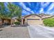 Charming single-story home featuring desert landscaping and a spacious driveway at 5342 W Maldonado Rd, Laveen, AZ 85339