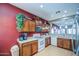 Features wood cabinets, white appliances, and pass-through window to adjacent dining and living areas at 5342 W Maldonado Rd, Laveen, AZ 85339