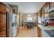 Kitchen with stainless steel refrigerator, wood cabinets, adjacent to dining area at 5342 W Maldonado Rd, Laveen, AZ 85339