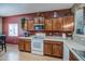 Kitchen features wood cabinets, white appliances, laminate countertops, and an eat-in area at 5342 W Maldonado Rd, Laveen, AZ 85339