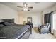 This is a main bedroom, which features a large bed, a ceiling fan, and natural light at 5342 W Maldonado Rd, Laveen, AZ 85339