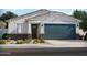 Charming single-story home featuring a two-car garage, stone accents, and a beautifully landscaped front yard at 5511 S 246Th Ave, Buckeye, AZ 85326